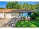 Tan and light blue house with attached garage and small front yard at 108 Clear Lake Cir, Sanford, FL 32773