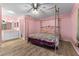 Bright bedroom with a large bed, ensuite bathroom access, and wood-look flooring at 108 Clear Lake Cir, Sanford, FL 32773