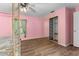 Cozy bedroom with mirrored closet doors and wood-look flooring at 108 Clear Lake Cir, Sanford, FL 32773