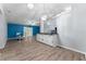 Open kitchen with island, white cabinets, and wood-look flooring at 108 Clear Lake Cir, Sanford, FL 32773