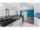 Modern kitchen with stainless steel appliances and a view into the living room at 108 Clear Lake Cir, Sanford, FL 32773