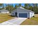 New construction home with gray exterior and blue garage door at 7883 Sw 138Th Street Rd, Ocala, FL 34473