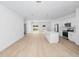 Open concept kitchen and living space with hardwood floors and island at 7883 Sw 138Th Street Rd, Ocala, FL 34473