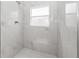 Walk in shower with hexagon tile floor and window at 7883 Sw 138Th Street Rd, Ocala, FL 34473