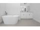 Bathroom with soaking tub, white cabinets, and gray floor at 7883 Sw 138Th Street Rd, Ocala, FL 34473