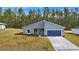 Newly built home with gray exterior and blue garage door at 7883 Sw 138Th Street Rd, Ocala, FL 34473