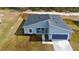 Aerial view of a new construction home with gray exterior and blue garage at 7883 Sw 138Th Street Rd, Ocala, FL 34473