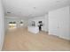 Open concept kitchen and living area with hardwood floors and an island at 7883 Sw 138Th Street Rd, Ocala, FL 34473