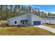 New construction home with gray exterior and blue garage door at 7883 Sw 138Th Street Rd, Ocala, FL 34473