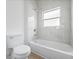 Clean bathroom with shower/tub combo and window at 7883 Sw 138Th Street Rd, Ocala, FL 34473