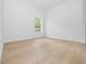 Simple bedroom with wood-look floors and a window at 7883 Sw 138Th Street Rd, Ocala, FL 34473