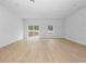 Spacious living area with sliding glass doors and wood-look floors at 7883 Sw 138Th Street Rd, Ocala, FL 34473