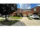 Townhouse exterior with two-car garage and landscaped lawn at 3167 Tocoa Cir, Kissimmee, FL 34746