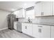 Modern white kitchen with granite countertops at 5416 Lake Underhill Rd, Orlando, FL 32807