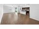 Open living space with hardwood floors and a view into the kitchen at 6122 Dolostone Dr, Lakeland, FL 33811