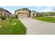 Front view of the house showcasing a driveway and landscaping at 6122 Dolostone Dr, Lakeland, FL 33811