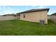 Home's backyard with grassy lawn and AC unit at 6122 Dolostone Dr, Lakeland, FL 33811