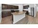 Modern kitchen with granite countertops and island at 6122 Dolostone Dr, Lakeland, FL 33811