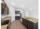 Modern kitchen with dark cabinets, granite counters, and stainless steel appliances at 6122 Dolostone Dr, Lakeland, FL 33811