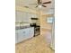 Modern kitchen with white cabinets, granite countertops, and stainless steel appliances at 117 N Observatory Dr, Orlando, FL 32835