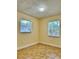 Bright bedroom with tile flooring and two windows at 117 N Observatory Dr, Orlando, FL 32835