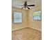 Bright bedroom with tile flooring and two windows at 117 N Observatory Dr, Orlando, FL 32835