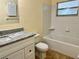 Clean bathroom with granite countertop, white cabinets, and a bathtub at 117 N Observatory Dr, Orlando, FL 32835
