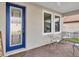 Inviting front porch with blue door and seating at 1890 Altavista Cir, Lakeland, FL 33810