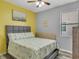 Bright bedroom with a queen-size bed and yellow accent wall at 1890 Altavista Cir, Lakeland, FL 33810