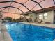 Inviting swimming pool with a covered patio area for relaxation at 1890 Altavista Cir, Lakeland, FL 33810