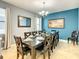 Formal dining room with large table and chandelier at 1471 Rolling Fairway Dr, Davenport, FL 33896