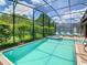 Inviting screened pool and spa with plenty of lounge chairs at 1471 Rolling Fairway Dr, Davenport, FL 33896