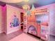 Charming bedroom with a castle-themed bunk bed and princess wall decor at 1471 Rolling Fairway Dr, Davenport, FL 33896