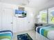 Bright bedroom with twin beds, beachy decor, and built-in storage at 2903 Hill St, New Smyrna Beach, FL 32169