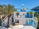 Quaint coastal cottage featuring a blue roof and white exterior at 2903 Hill St, New Smyrna Beach, FL 32169