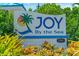 Joy By The Sea community sign with landscaping at 2903 Hill St, New Smyrna Beach, FL 32169