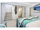 Bedroom with stairway, en-suite bathroom, and beach-themed bedding at 2903 Hill St, New Smyrna Beach, FL 32169