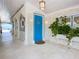Inviting entryway with a bright blue door and white tile flooring at 2903 Hill St, New Smyrna Beach, FL 32169