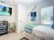 Charming bedroom with a twin bed, beach-themed decor, and a closet at 2903 Hill St, New Smyrna Beach, FL 32169