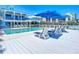White wood deck with lounge chairs and ocean view by the pool at 2903 Hill St, New Smyrna Beach, FL 32169