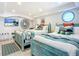 Bright bedroom with twin beds, coastal decor, and a large window at 2903 Hill St, New Smyrna Beach, FL 32169