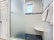 Modern shower with frosted glass enclosure and built-in seat at 2903 Hill St, New Smyrna Beach, FL 32169