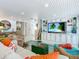 Bright living room with ocean view, comfy wicker furniture, and large TV at 2903 Hill St, New Smyrna Beach, FL 32169