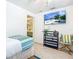 Bedroom with a single bed, shelving unit, and beachy decor at 2903 Hill St, New Smyrna Beach, FL 32169