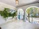 Relaxing covered patio with arched entryways and lush tropical plants at 2903 Hill St, New Smyrna Beach, FL 32169