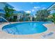 Inviting kidney-shaped pool surrounded by lush landscaping at 2903 Hill St, New Smyrna Beach, FL 32169
