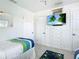 Bright bedroom with twin beds and built-in storage at 2903 Hill St, New Smyrna Beach, FL 32169