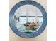 Living room view through a circular mosaic window, showing comfortable seating and ocean view at 2903 Hill St, New Smyrna Beach, FL 32169
