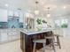 Modern kitchen with white cabinets, glass-top island and mosaic backsplash at 2903 Hill St, New Smyrna Beach, FL 32169