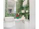 Stylish bathroom with a round sink, green mosaic tile, and glass shelves at 2903 Hill St, New Smyrna Beach, FL 32169